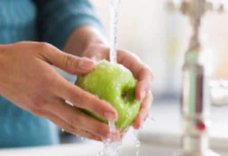 Photo: Woman washing a green apple